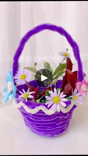 a basket filled with flowers sitting on top of a table