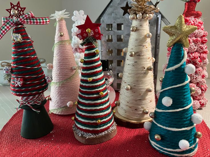 small christmas trees are lined up on a table