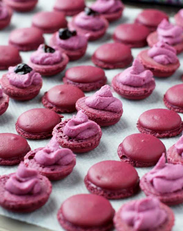 there are many pink macaroons that are on the baking sheet and ready to be baked