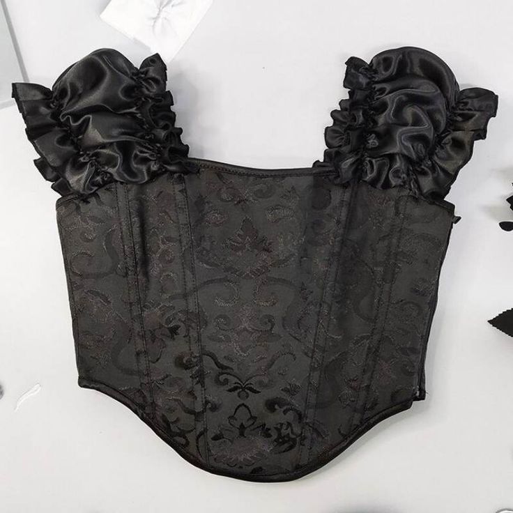 Opt for a style all in finesse with this steampunk embroidery corset. Ideal for a simple and sophisticated look. Type: Steampunk corset Materials : 90% Polyester, 10% spandex Decoration: embroidery Check your measurements, if you are between two sizes, take the larger one. Gothic Corset With Corset Back For Night Out, Gothic Ruffles Corset For Party, Gothic Underbust Corset For Party, Gothic Ruffled Corset For Party, Gothic Corset With Boned Bodice For Night Out, Gothic Boned Bodice Corset For Night Out, Fitted Gothic Corset Dress For Night Out, Black Underbust Corset With Ruffles, Elegant Fitted Halloween Corset Dress