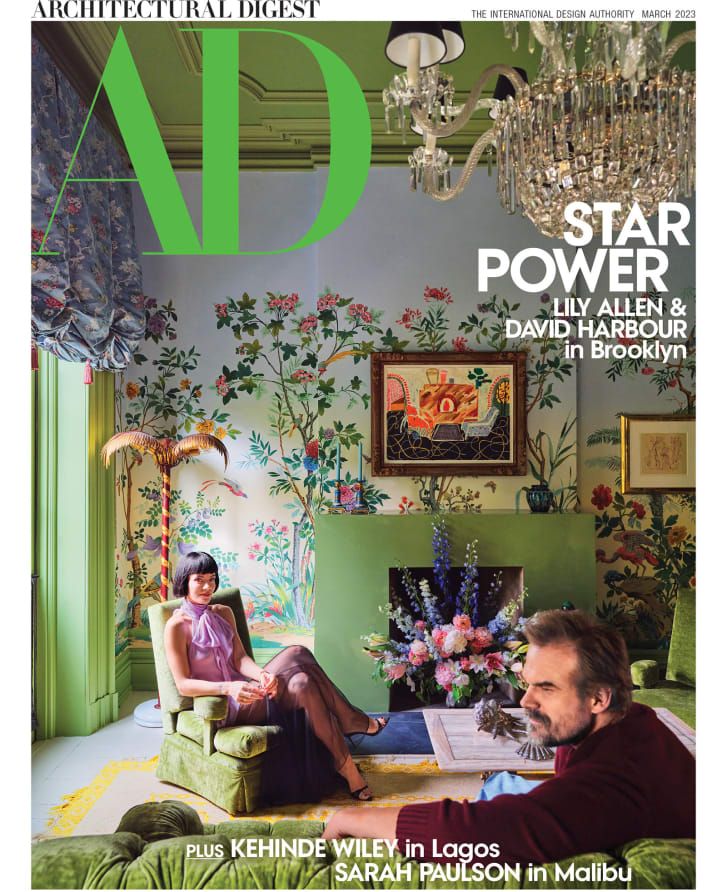 a man and woman sitting in a living room together on the cover of ad magazine