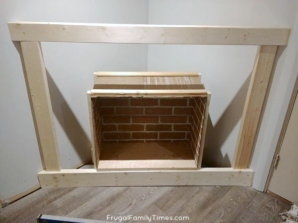 an unfinished fireplace surround made out of plywood