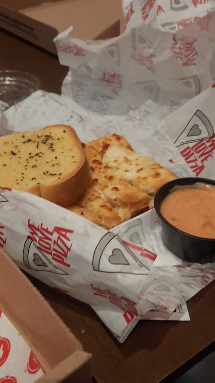 a box with some bread and sauce on it