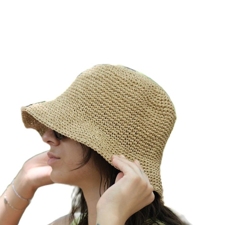 This hat is 100% handmade and crafted from raffia yarn. Raffia yarn is a natural and durable material, ensuring the hat's longevity. The wide brim of the hat is perfect for sun protection and offers a stylish look. This beige hat stands out with its simple and elegant design. It is an excellent accessory for both everyday use and outdoor activities like the beach. Its comfortable and lightweight structure ensures easy and prolonged wear. Raffia. You can store this hat, knitted from raffia rope, in a breathable cloth bag, protect it from fire and heat, and wipe the stains with a clean damp cloth. Lightweight Beige Straw Hat With Flat Brim, Straw Crochet Hat For Warm Weather, Lightweight Curved Brim Straw Hat, Lightweight Straw Hat With Short Brim, Curved Brim Straw Crochet Hat For Warm Weather, Wide Brim Toquilla Straw Crochet Hat, Lightweight Short Brim Paper Straw Hat, Beige Handwoven Toquilla Straw Hat, Warm Weather Curved Brim Crochet Straw Hat