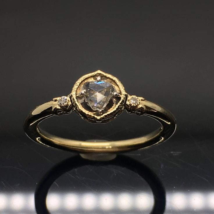 14K Rose Cut Diamond Engagement Ring METAL: 14K Yellow Gold TOTAL WEIGHT: 3.0 g (approximate, varies per size) SIDE DIAMONDS: Round Brilliant Cut Diamonds COLOR: G/H CLARITY: VS2 CENTER STONE: Old Rose Cut Diamond These diamonds are repurposed from antique jewelry. Each diamond is one of a kind. Shapes and sizes will vary per order! SIZE: Ladies size 4-9. Please indicate your ring size at checkout. DESCRIPTION: This ring is beautiful! The center features an old, rose cut diamond. They also have Yellow Gold Heart Cut Ring With Rose Cut Diamonds, Luxury 14k Rose Gold Heart Ring, Rose Gold Heart Cut Rings With Rose Cut Diamonds, Rose Gold Rings With Heart-cut Rose Diamonds, Luxury Gold Halo Ring With Rose Cut Diamonds, Gold Heart Ring With Rose Cut Diamonds For Promise, Luxury Halo Ring With Rose Cut Diamonds For Gift, Gold Heart Cut Rings With Rose Cut Diamonds, Gold Heart Ring With Rose Cut Diamonds