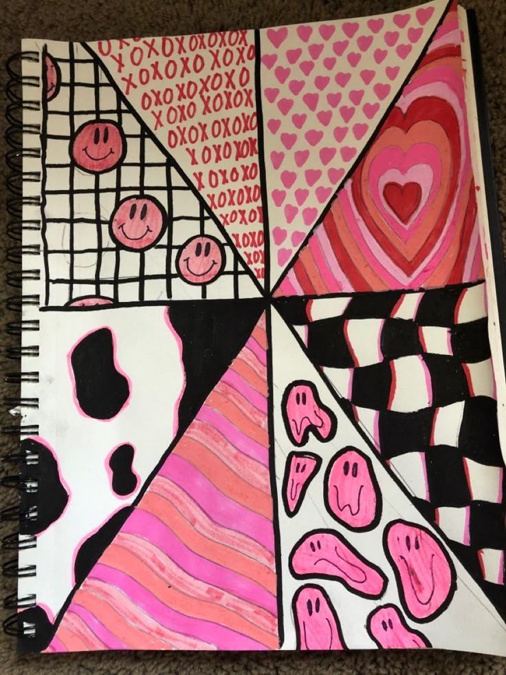 an art journal with pink and black designs on it, sitting on the floor in front of a carpet