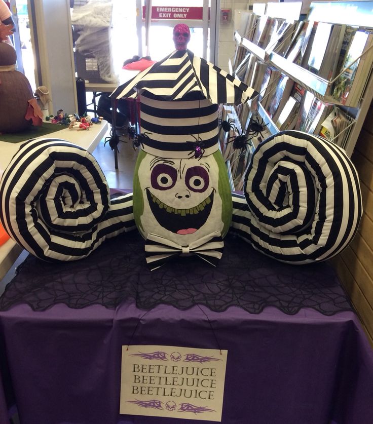 two stuffed animals sitting on top of a purple table