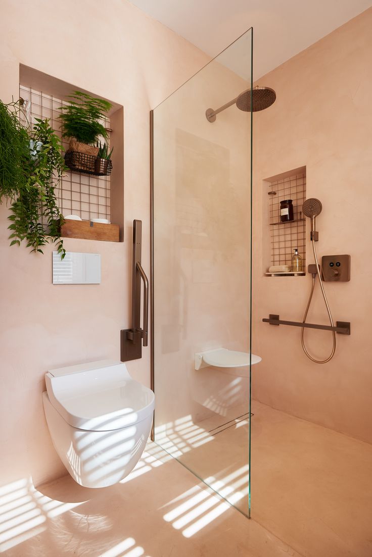 a bathroom with a toilet, shower and plants on the shelves in it's corner