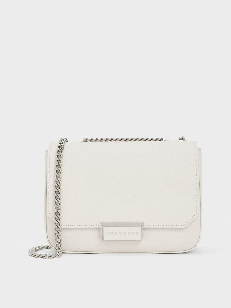 This product is made with at least 20% sustainable materials by weight. CHARLES & KEITH uses recycled, degradable, organic, and water-based materials in our eco-conscious collection. White and silver make for a timelessly chic combination, especially when seen on this classic chain strap shoulder bag. It is roomy enough to hold all your daily essentials when you are on the go, while looking clean, compact and polished. Reach for this to instantly elevate your white tee and jeans ensemble - it is the perfect companion for errand runs and lunch breaks. White Tee And Jeans, Size Chart For Kids, Charts For Kids, Charles Keith, Printables Kids, White Tee, Belt Size, White Bag, Chain Strap