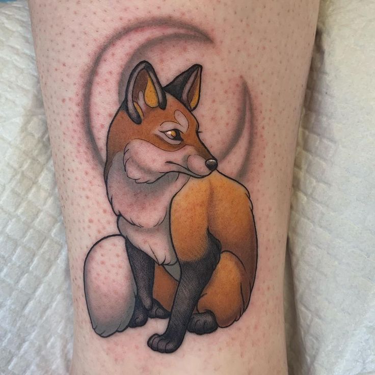 a small tattoo of a fox on the leg