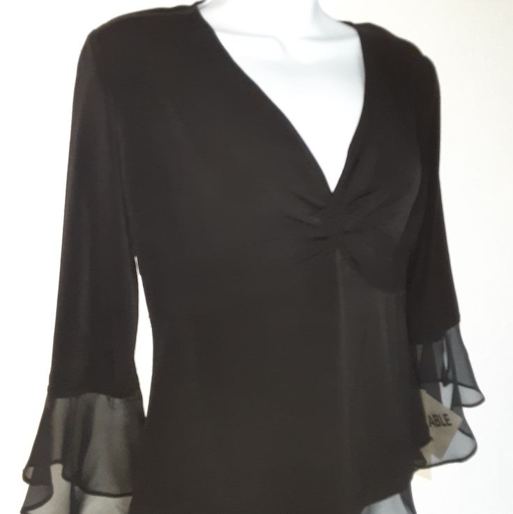 Elegant Black Blouse With Black Sheer End Sleeve And Skirting. Ruched Neckline. 93% Polyester 7% Spandex. New With Tags! Bundle 2+ Items From My Closet For Special Discounts! Reasonable Offers Welcome!I Guarenteed Shipping Next Business Day! >>Catfriendlyhome<< Black Fitted Top For Formal Occasions, Black Fitted Formal Top, Elegant Stretch Tops For Formal Occasions, Black Stretch Blouse For Formal Occasions, Formal Black Stretch Blouse, Elegant Stretch Tops For Night Out, Formal Black Fitted Blouse, Elegant Black Stretch Tops, Fitted V-neck Blouse For Evening