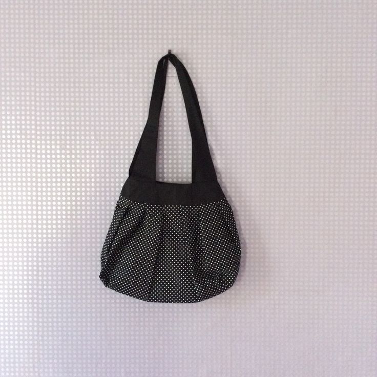 A handcrafted polka dot shoulder bag, incorporating a key trend from the catwalk this season.  The bag has 2 shoulder straps made in a black cotton fabric, measuring 73cm. The bag is fully lined and is machine washable.  The bag measures approx 32 x 38cm. Black Cotton Shoulder Bag, Black Cotton Satchel Shoulder Bag, Polka Dot Shoulder Bag For Daily Use, Black Fabric Shopping Bag, Black And White Tote Shoulder Bag For Everyday Use, Black Fabric Bags For Daily Use, Black Fabric Bag For Daily Use, Black Cotton Shoulder Bag With Removable Pouch, Black Cotton Tote Hobo Bag