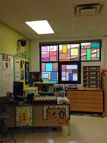 the classroom is decorated with colorful windows and lots of clutter on the desks