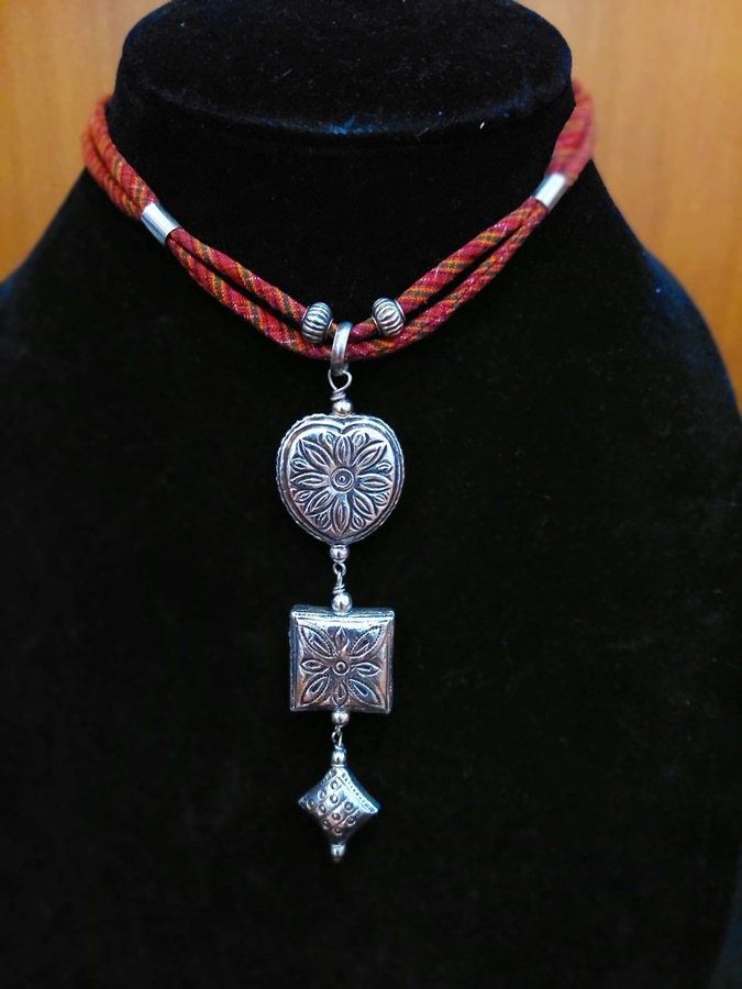 925 Sterling Silver Tribal Ethnics Thai Beads Design Hand Emboss Thai Silk Redd Choker Necklace 16" Double lines This necklace is a handmade and traditional old design made by an old craftsmen in a small village in Surin Province. Its design and pattern are a mixture between Thai and Cambodia's culture and ethnics. There are just a few people who can make this design and need to put much efforts and time, nearly a month, to finish one beautiful piece. This necklace can entail and being a heritag Traditional Adjustable Sterling Silver Necklaces, Traditional Adjustable Silver Beaded Necklace, Traditional Adjustable Silver Beaded Necklaces, Traditional Adjustable Necklace With Silver Beads, Red Necklaces With Silver Beads For Festival, Red Necklace With Silver Beads For Festival, Traditional Sterling Silver Necklace For Festivals, Traditional Adjustable Engraved Necklaces, Red Bohemian Temple Necklace As Gift