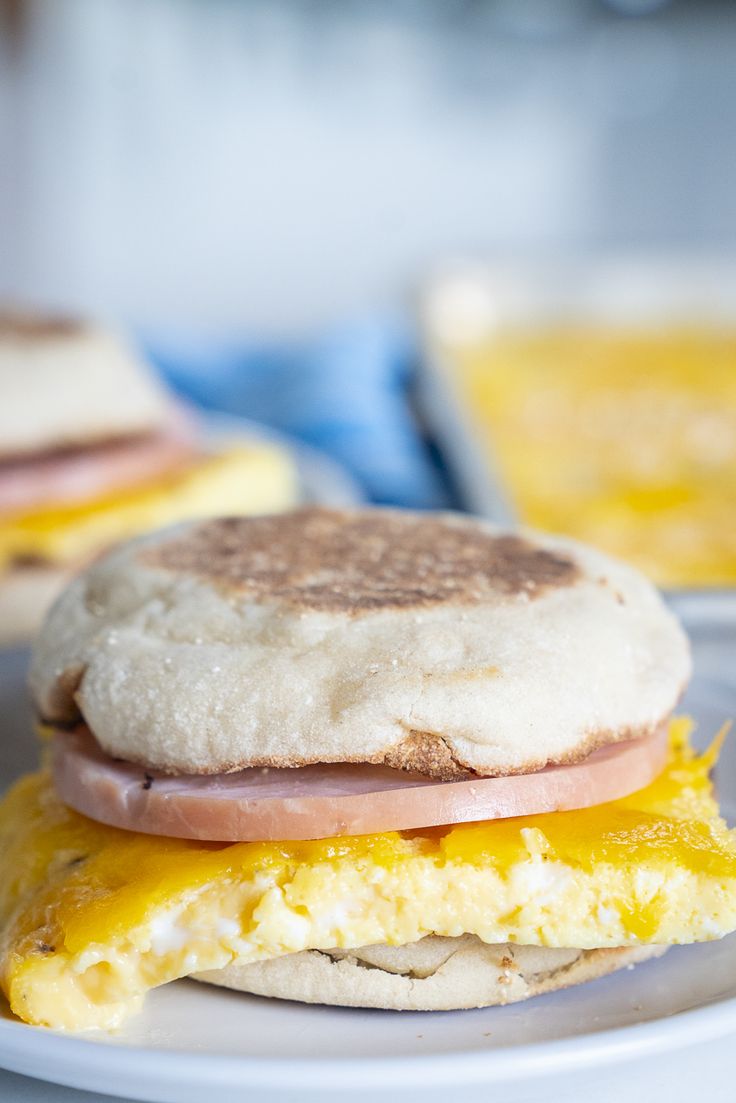 an egg, ham and cheese sandwich on a plate