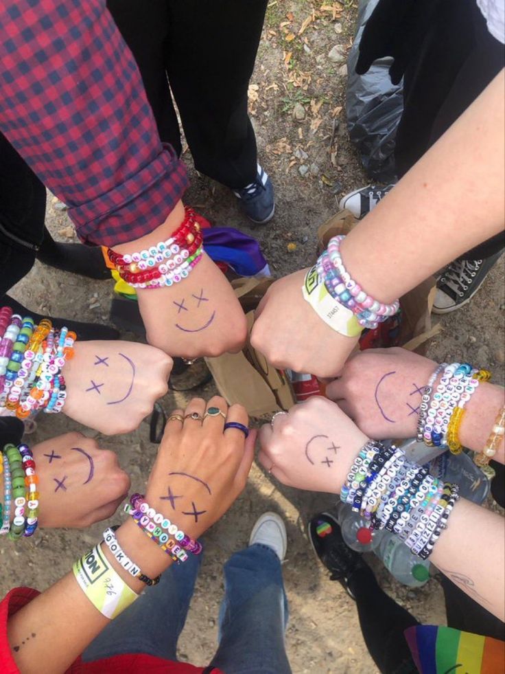 a group of people standing in a circle with their hands on top of each other