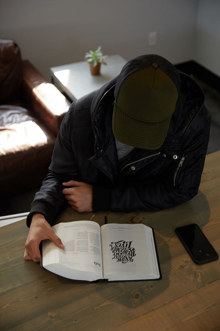 a man sitting at a table with an open book