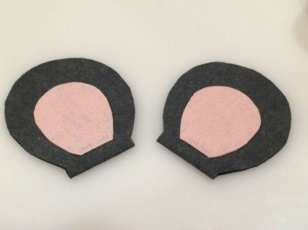 two black and pink circles are shown on a white surface