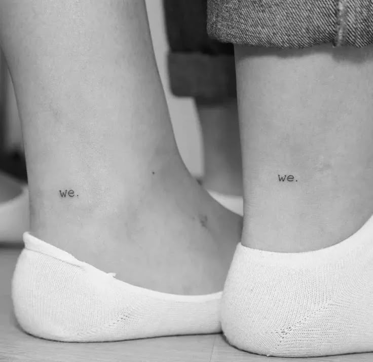 two people with small tattoos on their legs, one has the words we are together