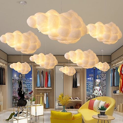 a room filled with furniture and lots of clouds hanging from the ceiling