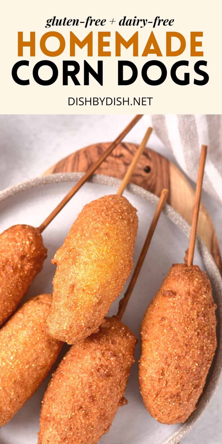 homemade corn dogs on a plate with toothpicks in the middle and text overlay