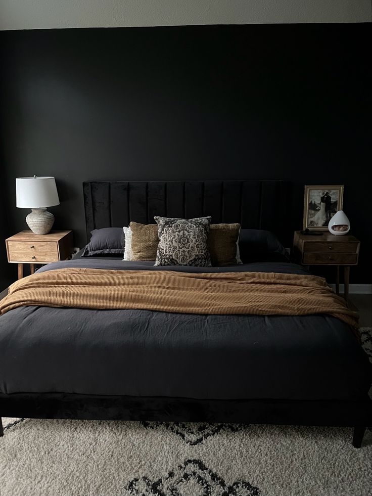 Black boho bedroom, modern organic, king bed with black linen duvet, black velvet headboard, natural wood nightstands, stone lamp, olive green velvet goose feather pillows, and burnt orange throw blanket Black Headboard Bedroom, Black Velvet Bed, Statement Bedroom, Tan Bedroom, Olive Green Bedrooms, Bedroom Mirrors, Velvet Bed Frame, Black Bed Frame, Grey Bedroom Decor