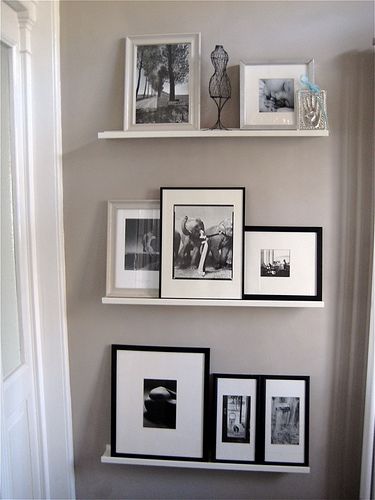 the wall is filled with pictures and frames