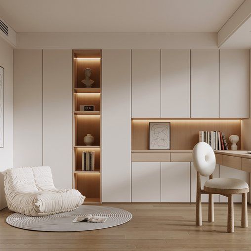 a living room filled with furniture and bookshelves next to a desk on top of a hard wood floor