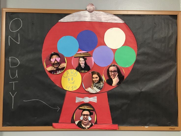 a bulletin board with pictures of people in the shape of a gummy bear and balloons