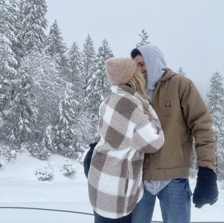 a man and woman walking in the snow