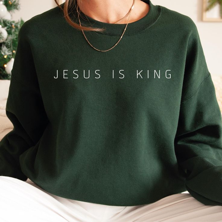 *If you would like a colour or size that is not listed, please contact us. Share your faith boldly with the "Jesus Is King" Sweatshirt, a perfect way to express your devotion and inspire others. ✝️ This stylish and comfortable tee is ideal for daily wear, church gatherings, or as a thoughtful gift for fellow believers. Made from soft, breathable cotton for all-day comfort, perfect for layering or wearing on its own. Available in various sizes, ensuring a great fit for men and women of all ages. Modest Christian Clothing, Christian Shirts Designs, Jesus Is King, Modesty Outfits, Faith Clothing, King Design, Gildan Sweatshirt, Church Events, Cute Shirt Designs