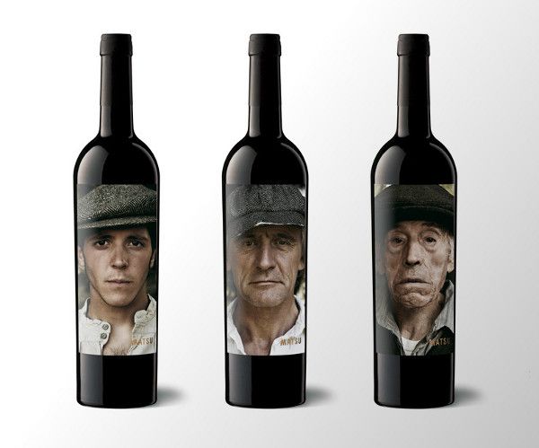 three bottles of wine with the faces of two men and one woman in hats on them