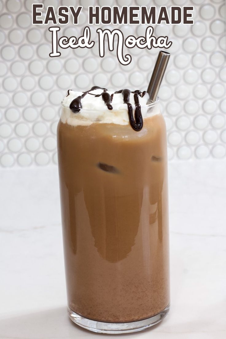 a tall glass filled with ice cream and chocolate milkshake on top of a white counter