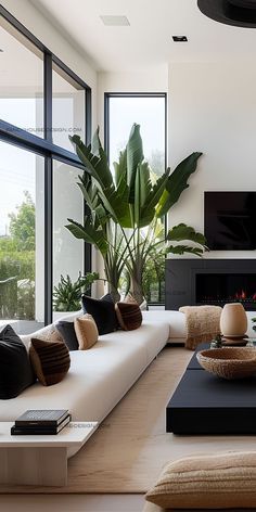 a modern living room with large windows and white couches