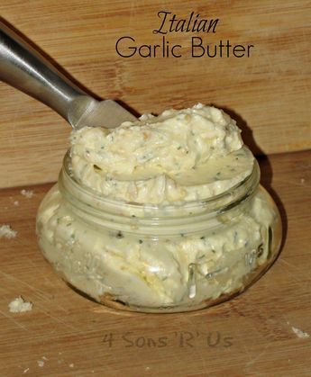 a jar filled with white sauce sitting on top of a wooden table next to a knife