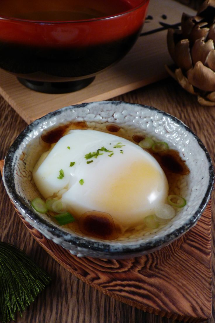 a bowl filled with food on top of a wooden table