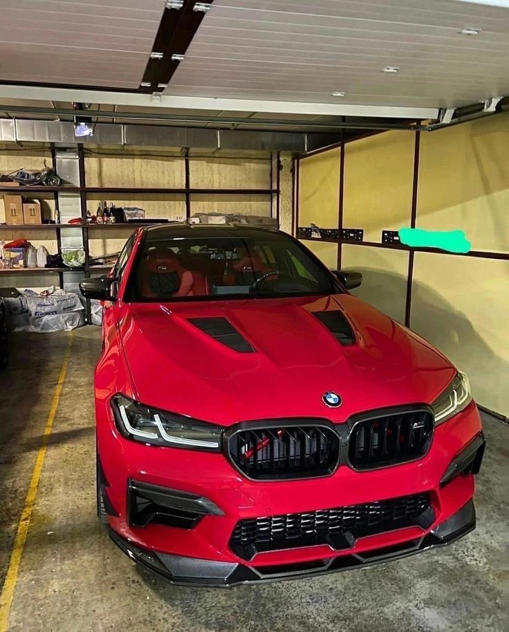 a red car is parked in a garage