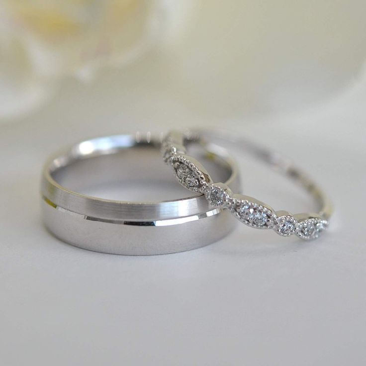 two wedding rings sitting on top of each other