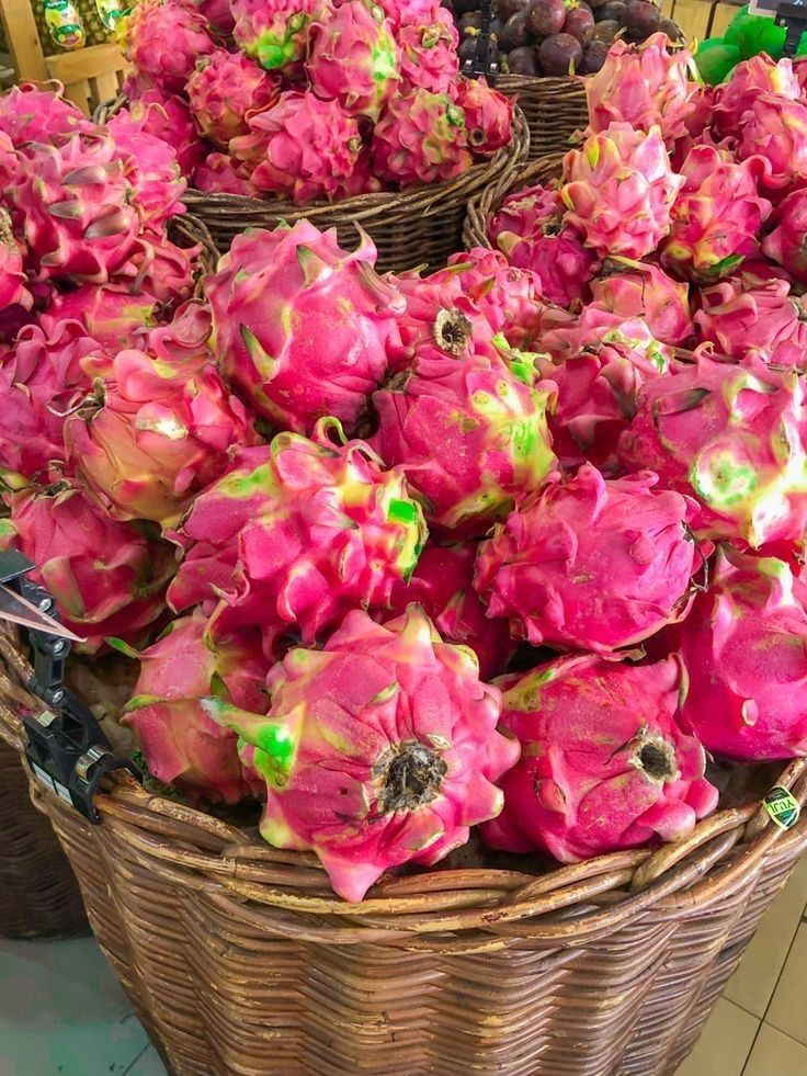 baskets filled with dragon fruit on display in a store