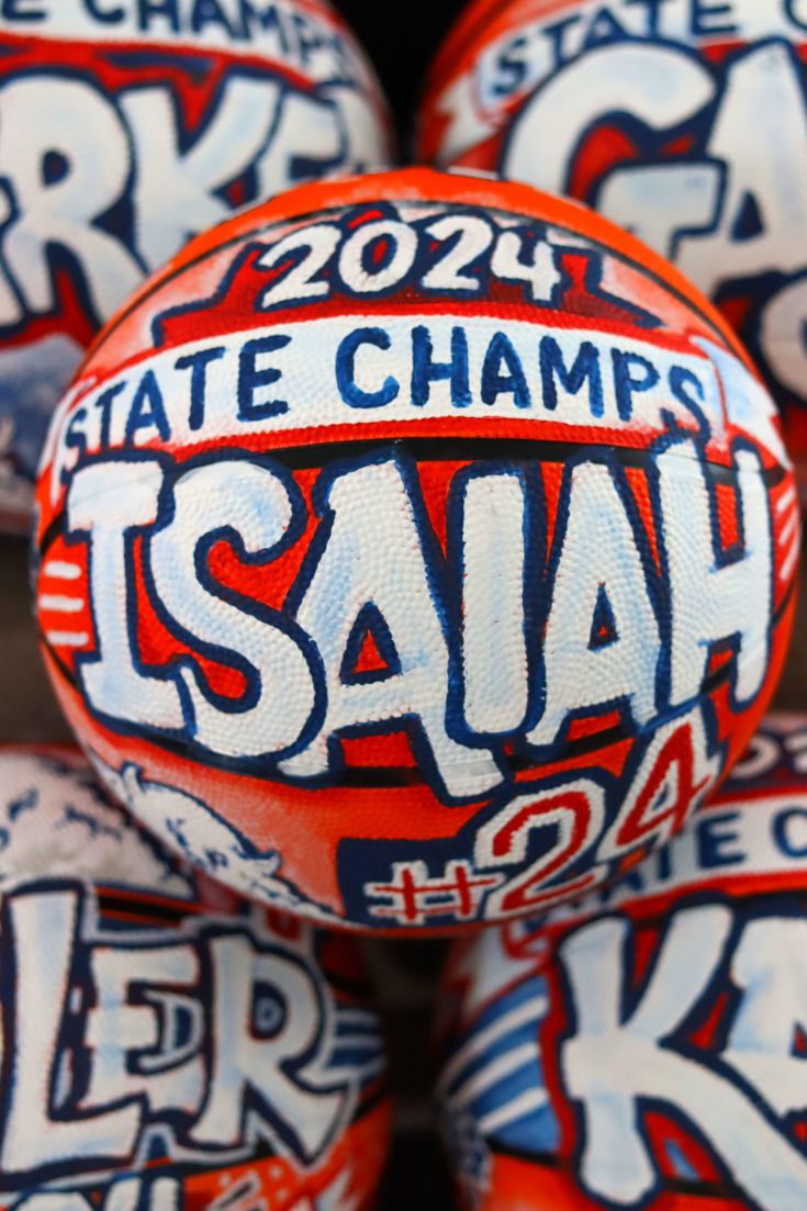 several orange and white basketballs with the words kansas state champs on them are stacked in a pile