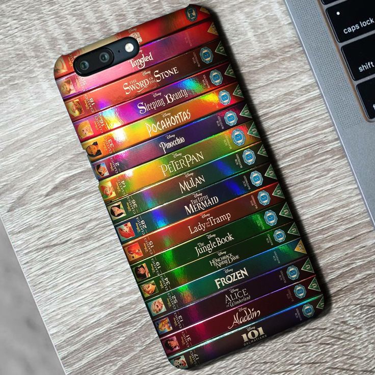 a cell phone case with the names of movies on it next to a laptop computer