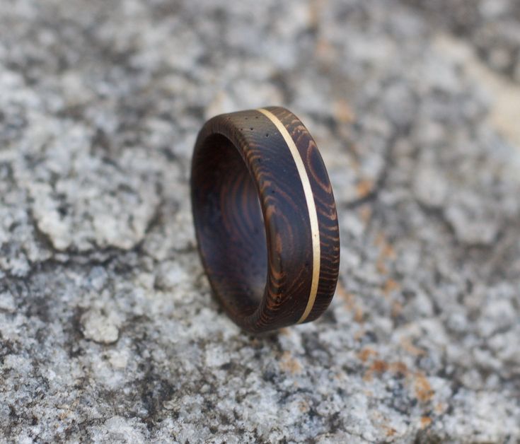 a wooden ring sitting on top of a rock