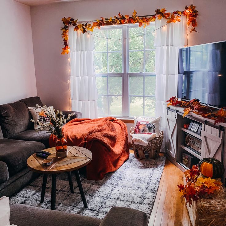 a living room filled with furniture and a flat screen tv sitting on top of a wooden table