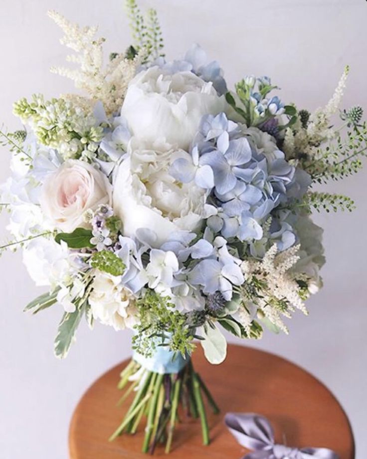 a bouquet of flowers sitting on top of a wooden table