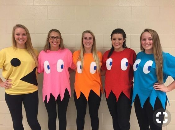 four girls in costumes standing next to each other with their hands on their hipss