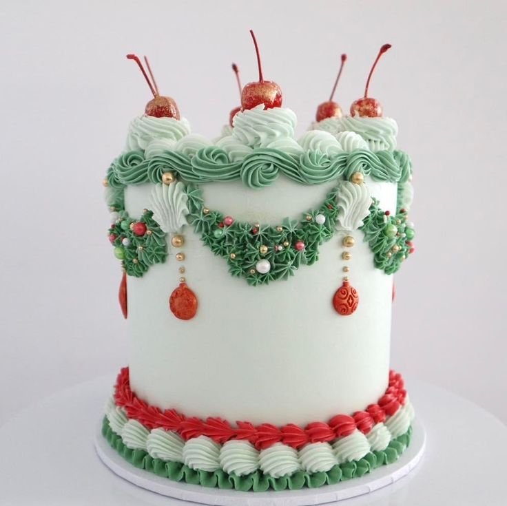 a white cake with green and red decorations