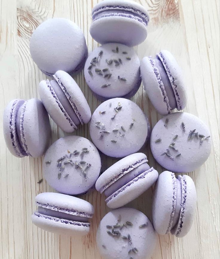 purple macaroons with lavender frosting and sprinkles arranged in a circle