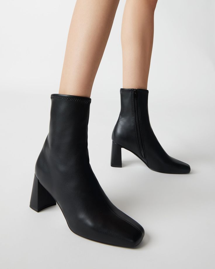 For the perfect seasonal transition style, look no further. HUSH is a sleek ankle boot with a sock-like fit and brings a chic touch to these versatile booties. 2.75 inch heel height 9.5 inch shaft circumference 6.25 inch shaft height Vegan leather or synthetic upper material Textile and vegan leather lining Vegan leather sock Synthetic sole Imported Black Boots Outfit, Women's Booties, Steve Madden Store, Socks And Heels, Leather Socks, Black Square, Boots Outfit, Midi Dresses, Hush Hush