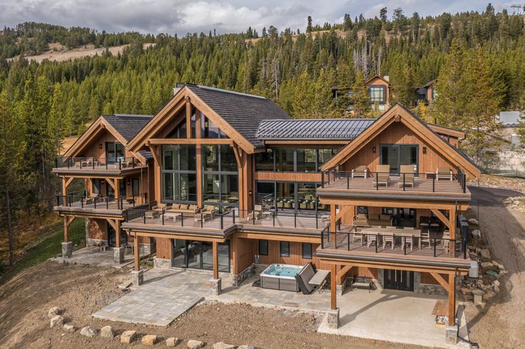 an aerial view of a large house with lots of wood and glass on the front