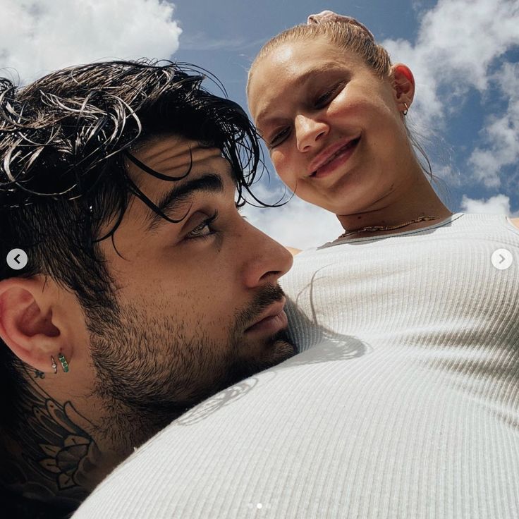 a man and woman looking at each other while they are cuddling in the sky